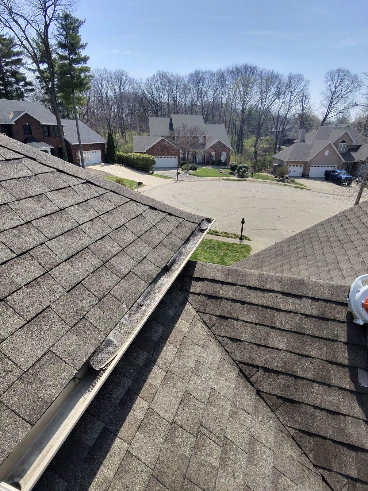 Gutter cleaning — roof with gutter guards (Topclean job)