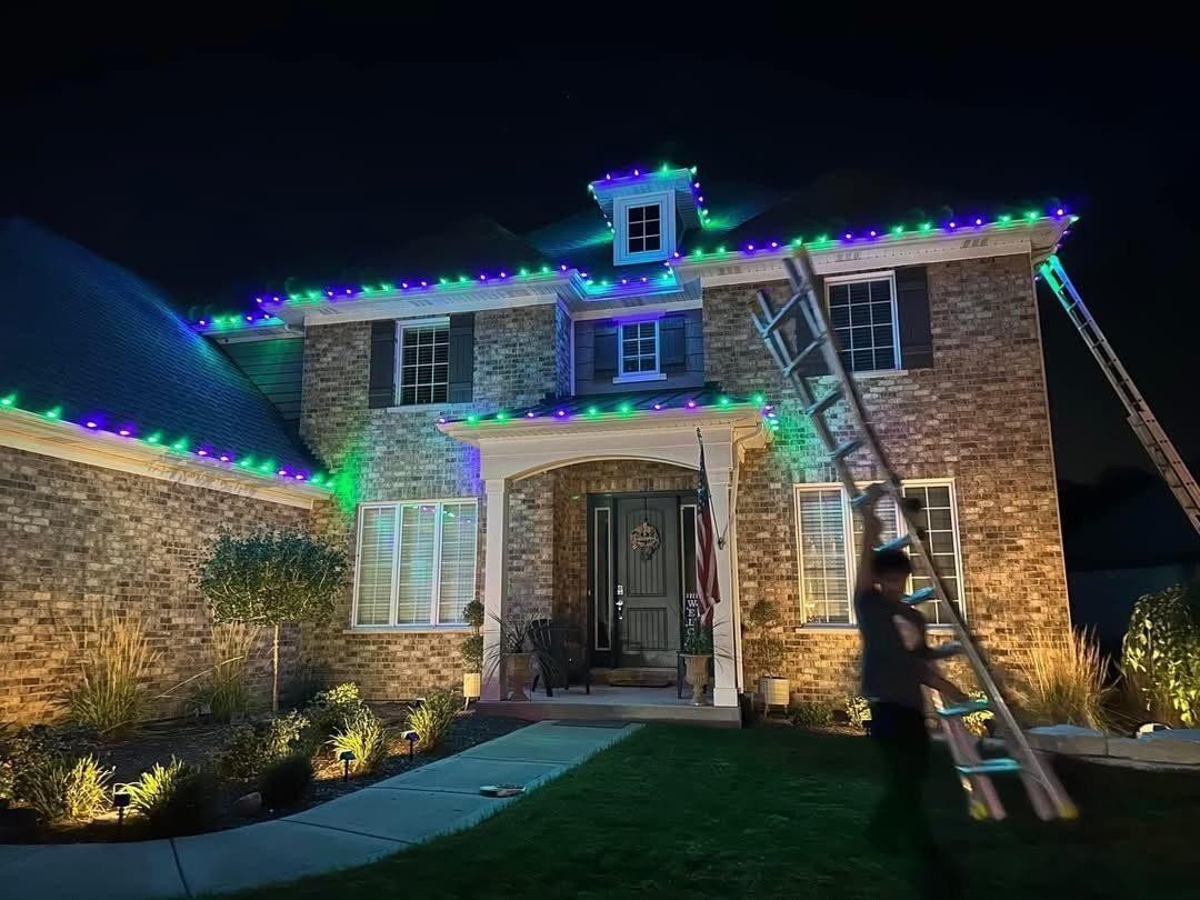Holiday lights — purple and green roofline with crew