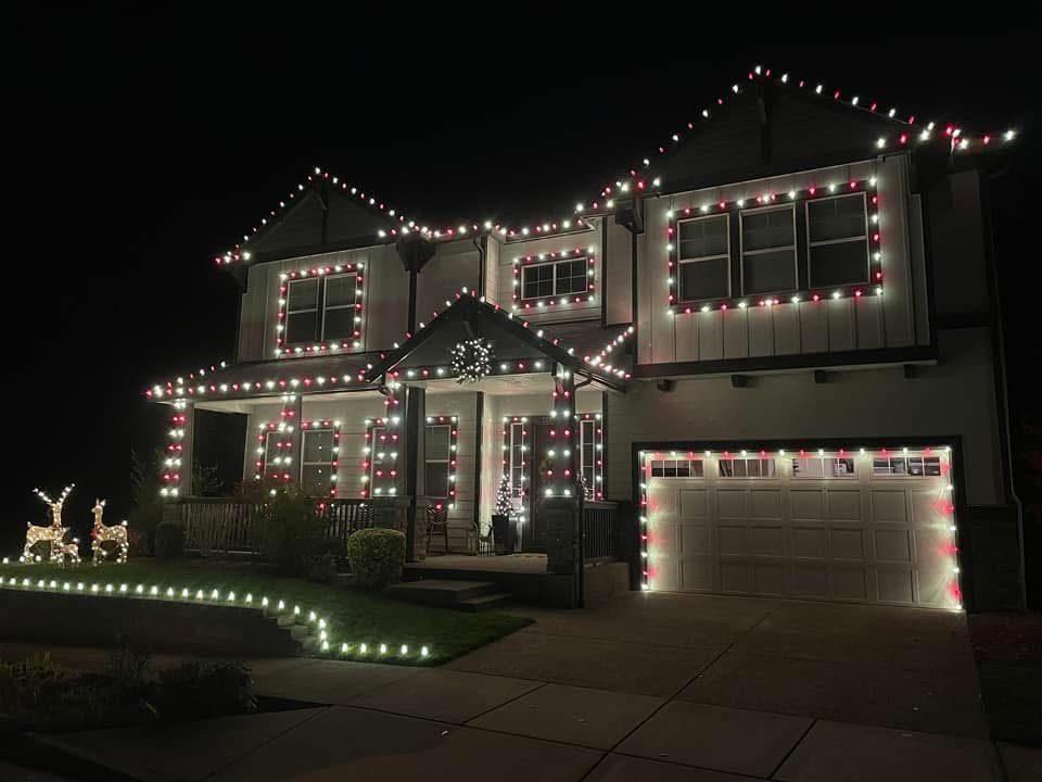 Holiday lights — red and white farmhouse porch and roofline