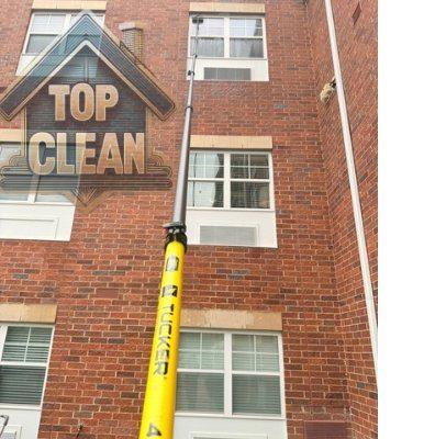 Window cleaning — Tucker pole on brick commercial building